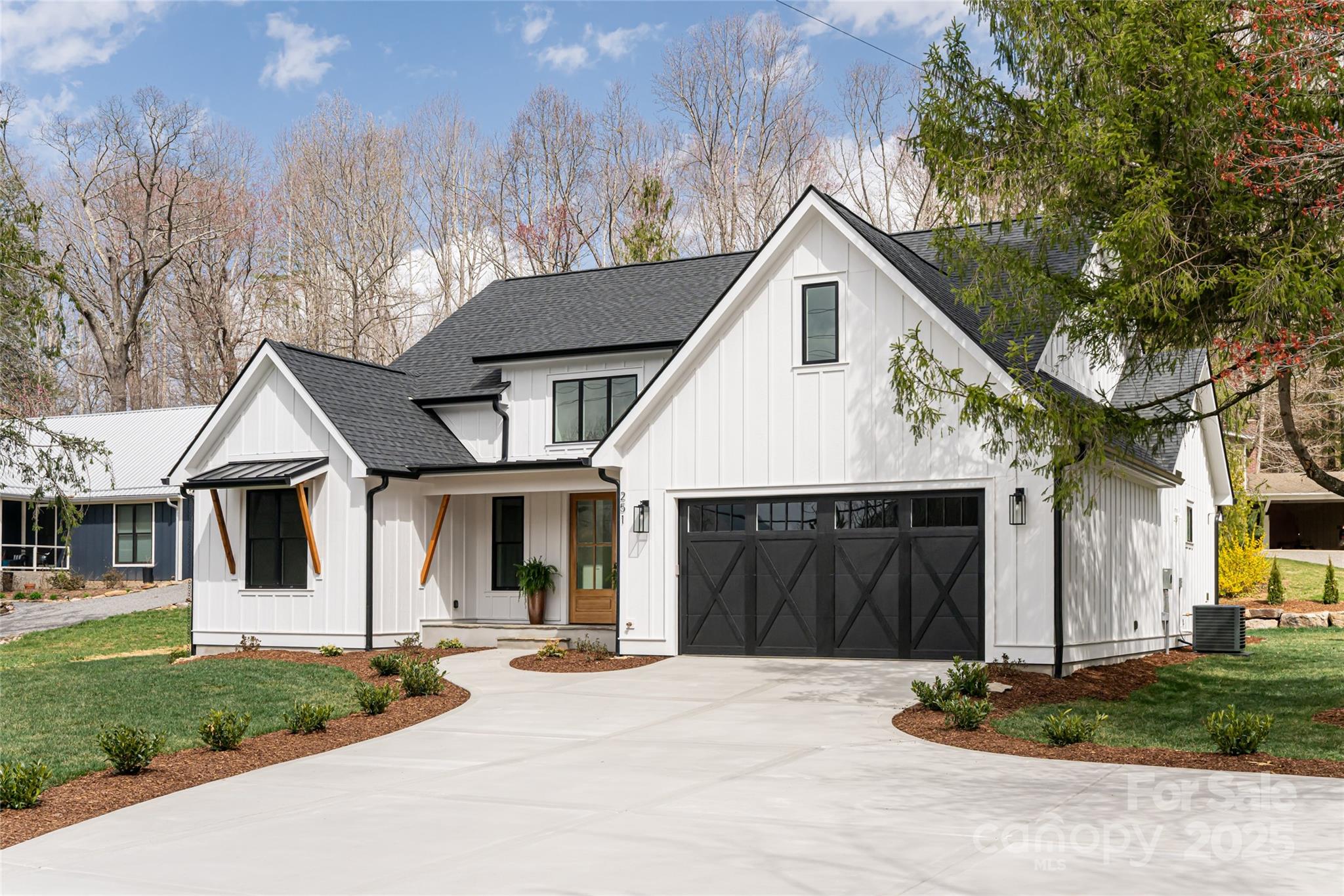 251 Bee Tree Road Swannanoa, NC 28778 - Photo 1 of 46 a front view of a house with a yard and garage