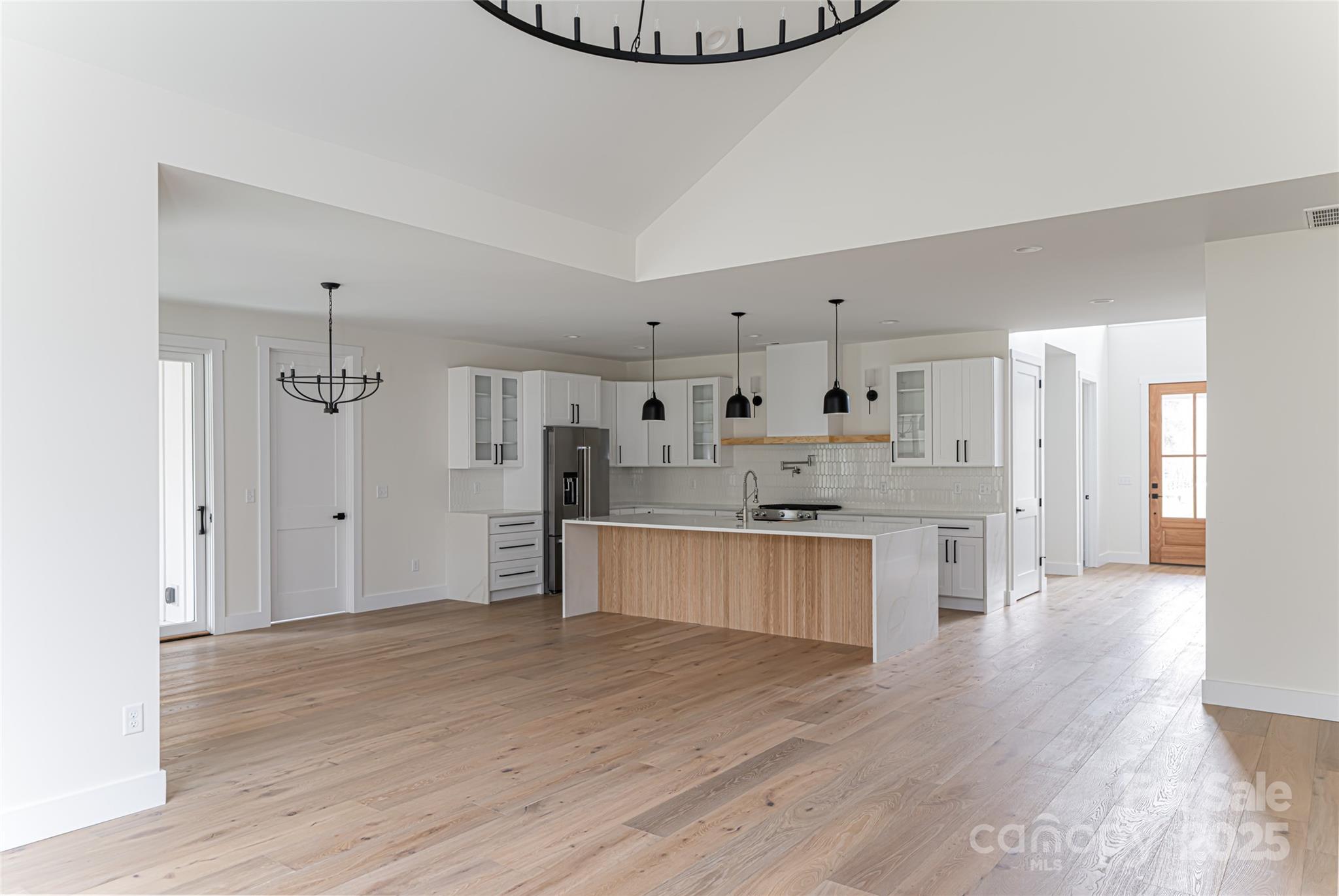 251 Bee Tree Road Swannanoa, NC 28778 - Photo 17 of 46 a large kitchen with cabinets wooden floor and stainless steel appliances