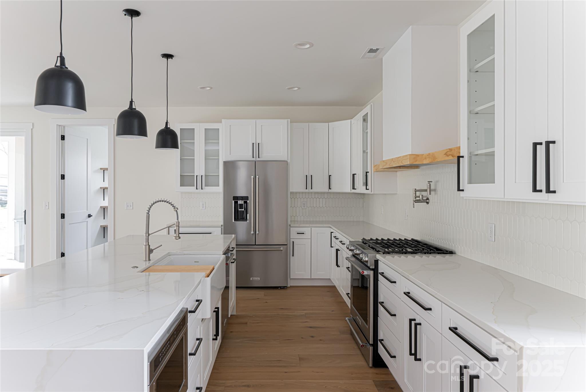 251 Bee Tree Road Swannanoa, NC 28778 - Photo 19 of 46 a kitchen with stainless steel appliances a sink a stove a refrigerator and cabinets