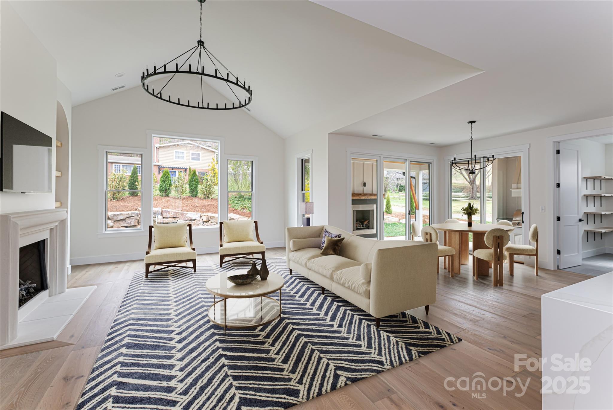 251 Bee Tree Road Swannanoa, NC 28778 - Photo 2 of 46 a living room with furniture a fireplace and a chandelier