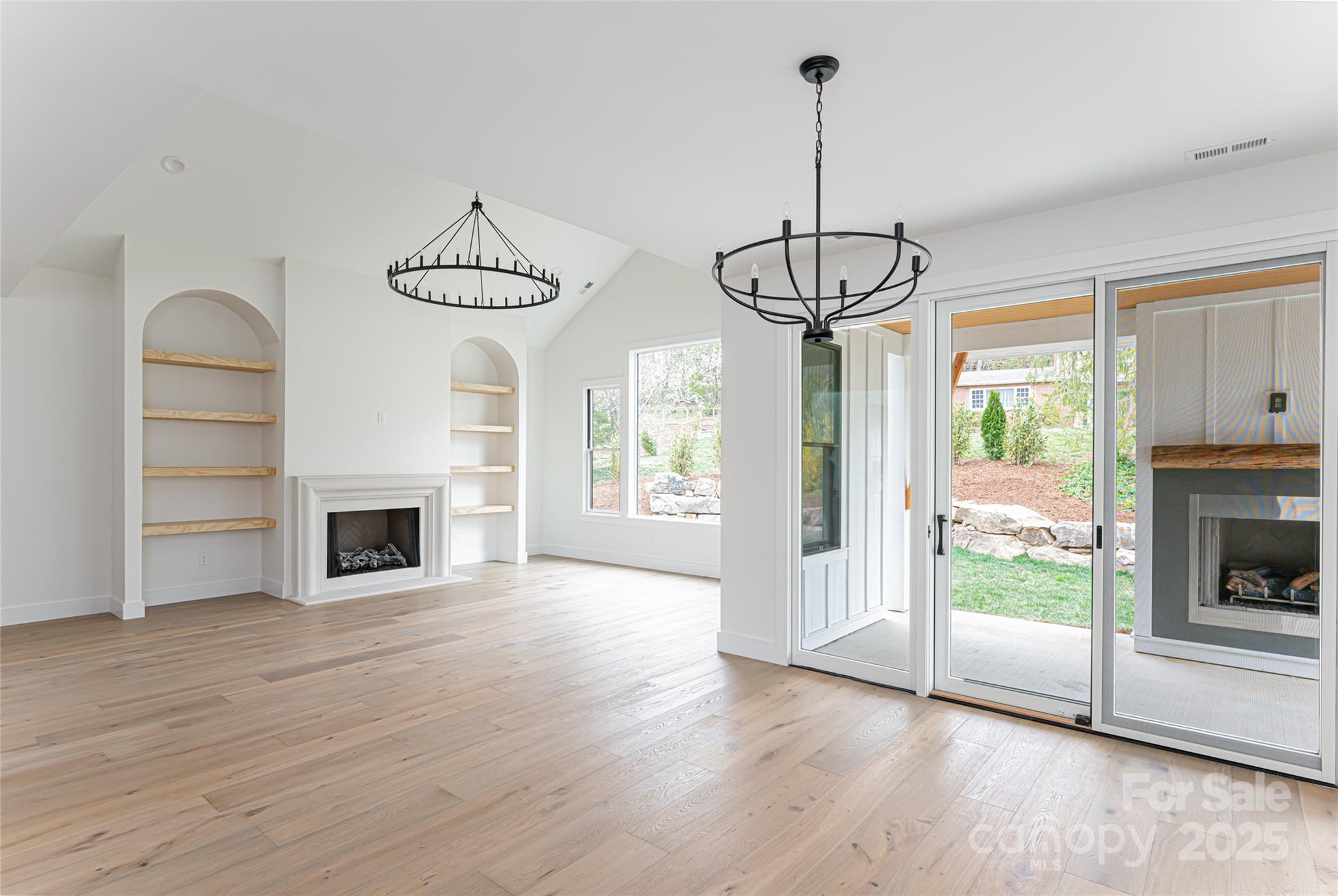 251 Bee Tree Road Swannanoa, NC 28778 - Photo 22 of 46 a view of a room with wooden floor fireplace and windows