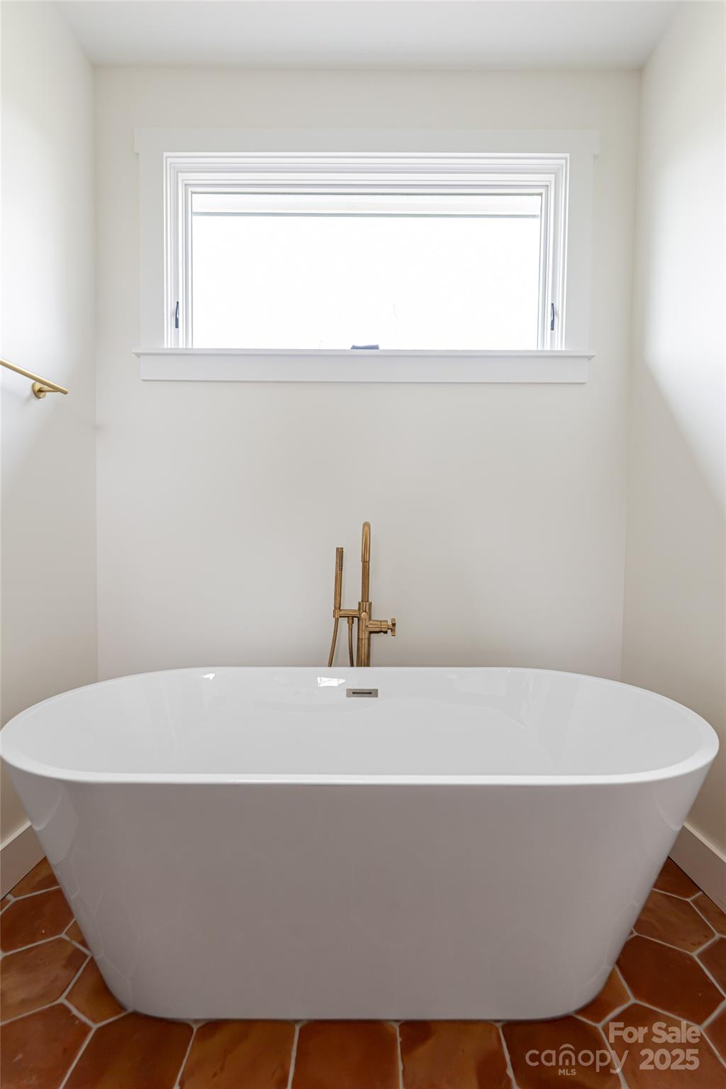 251 Bee Tree Road Swannanoa, NC 28778 - Photo 28 of 46 a white bath tub sitting in a bathroom