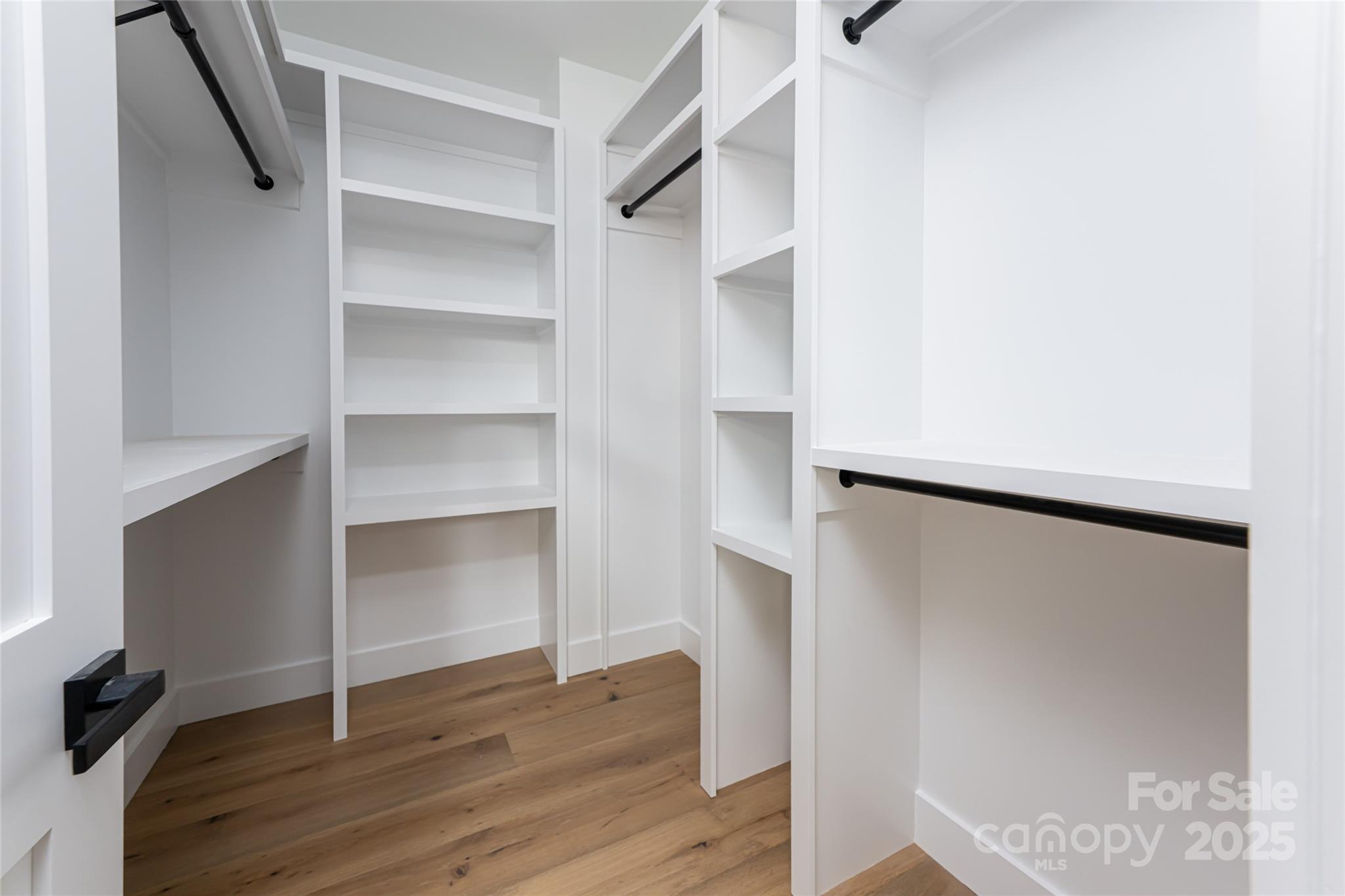 251 Bee Tree Road Swannanoa, NC 28778 - Photo 30 of 46 a view of walk in closet with empty racks