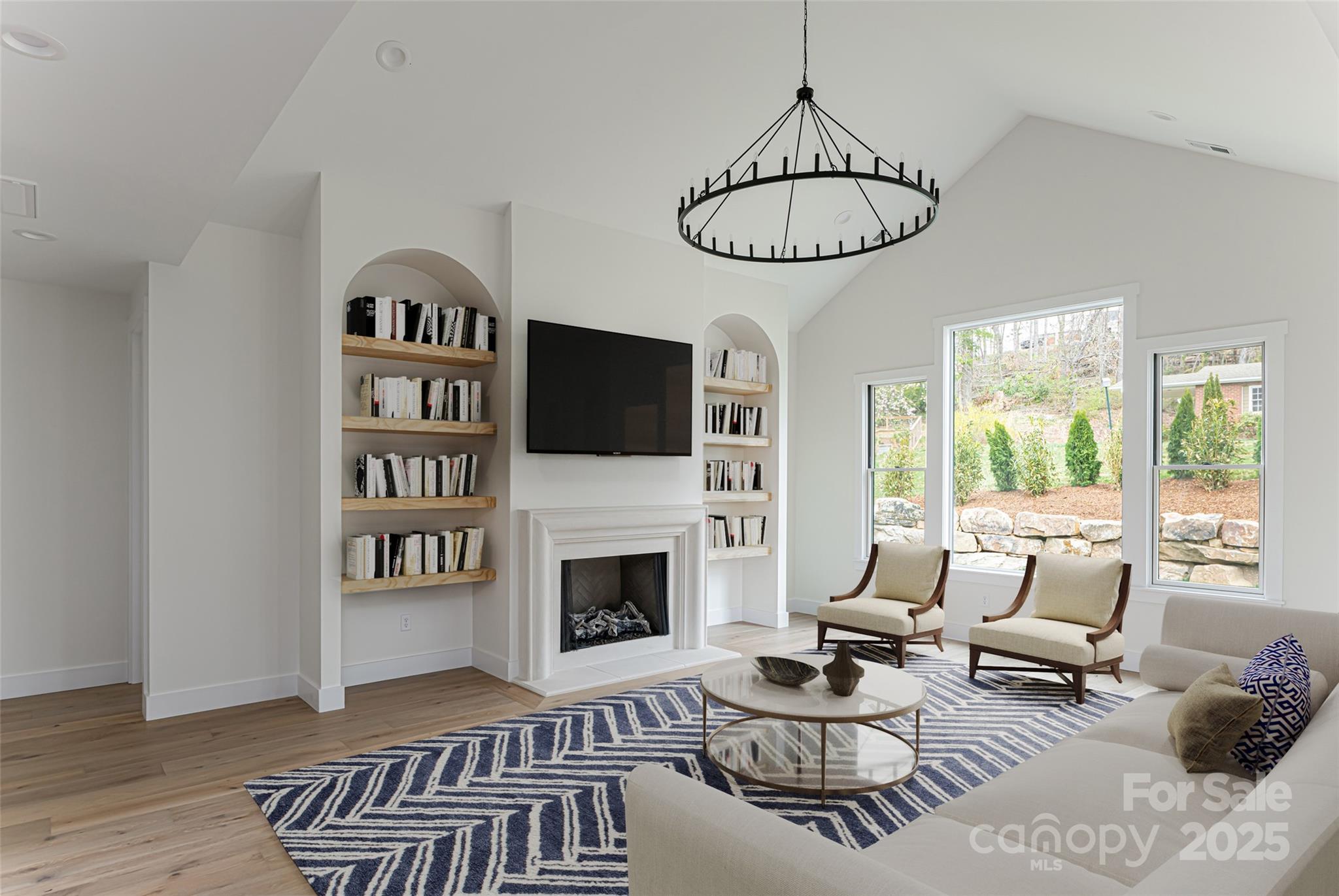 251 Bee Tree Road Swannanoa, NC 28778 - Photo 3 of 46 a living room with furniture a rug and a fireplace