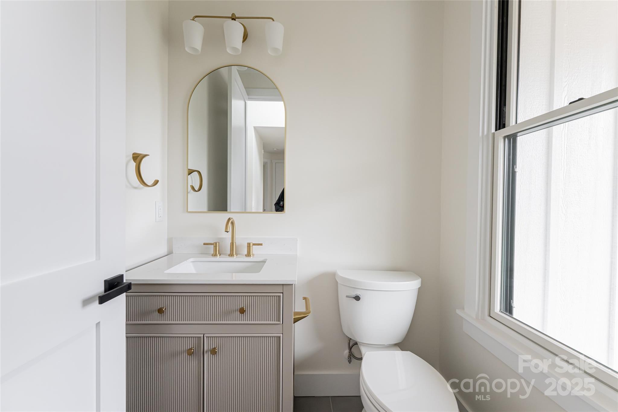 251 Bee Tree Road Swannanoa, NC 28778 - Photo 31 of 46 a bathroom with a toilet sink and mirror