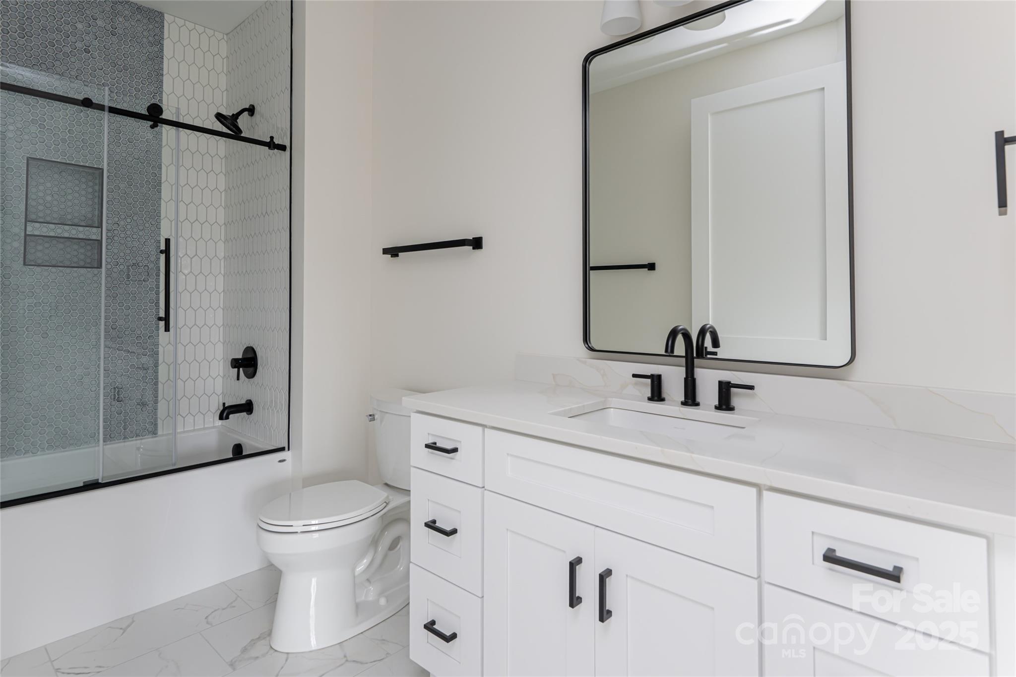 251 Bee Tree Road Swannanoa, NC 28778 - Photo 33 of 46 a bathroom with a toilet sink a mirror and shower
