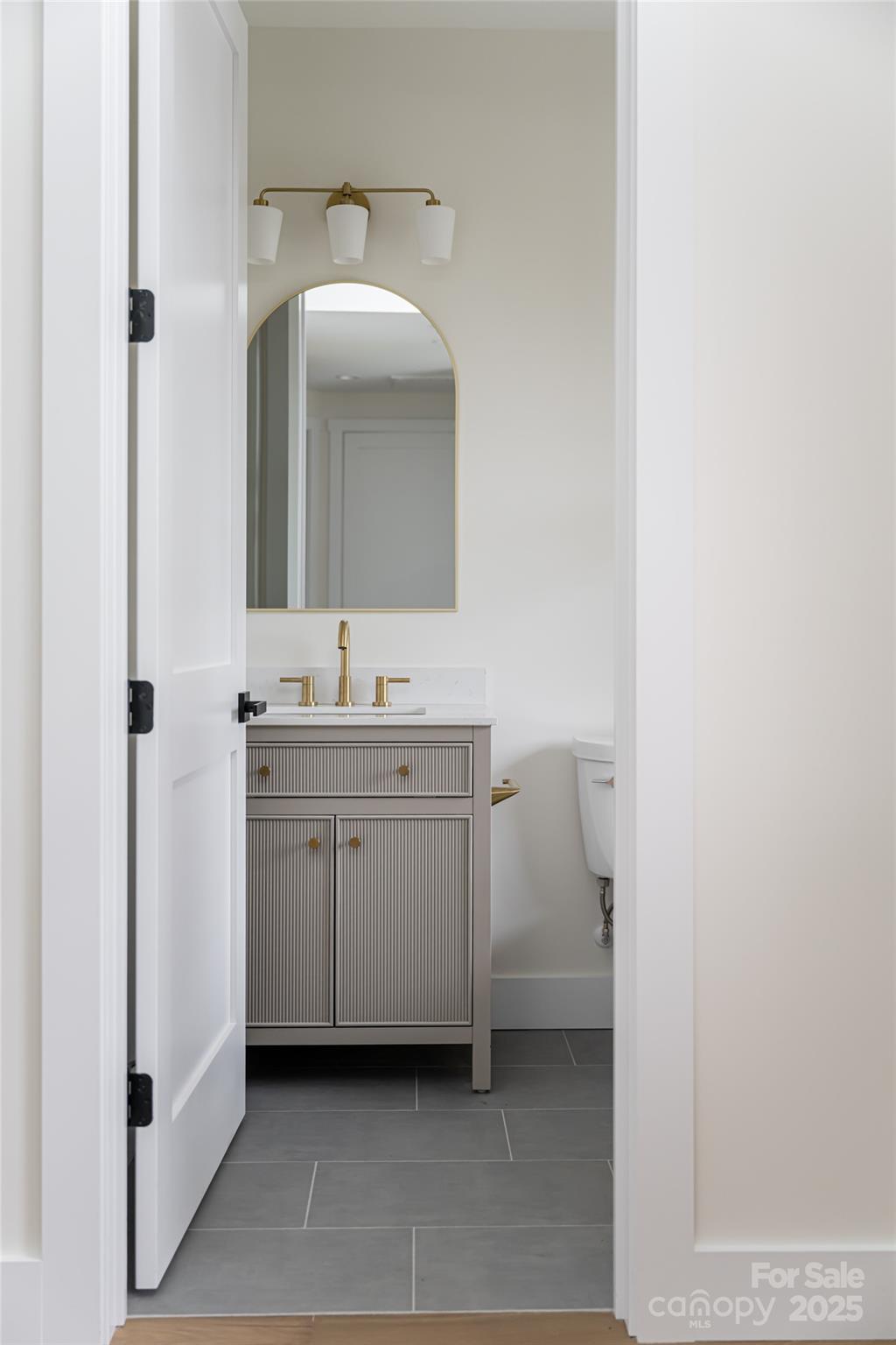 251 Bee Tree Road Swannanoa, NC 28778 - Photo 35 of 46 a bathroom with a toilet sink and mirror