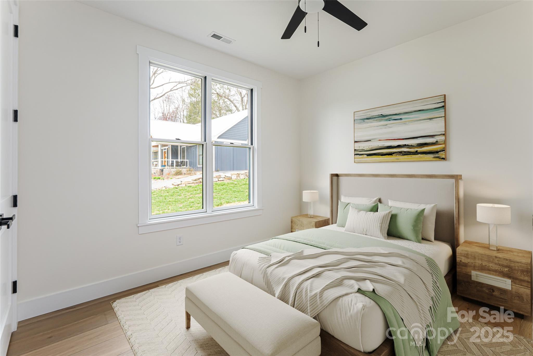 251 Bee Tree Road Swannanoa, NC 28778 - Photo 36 of 46 a bedroom with a bed and wooden floor