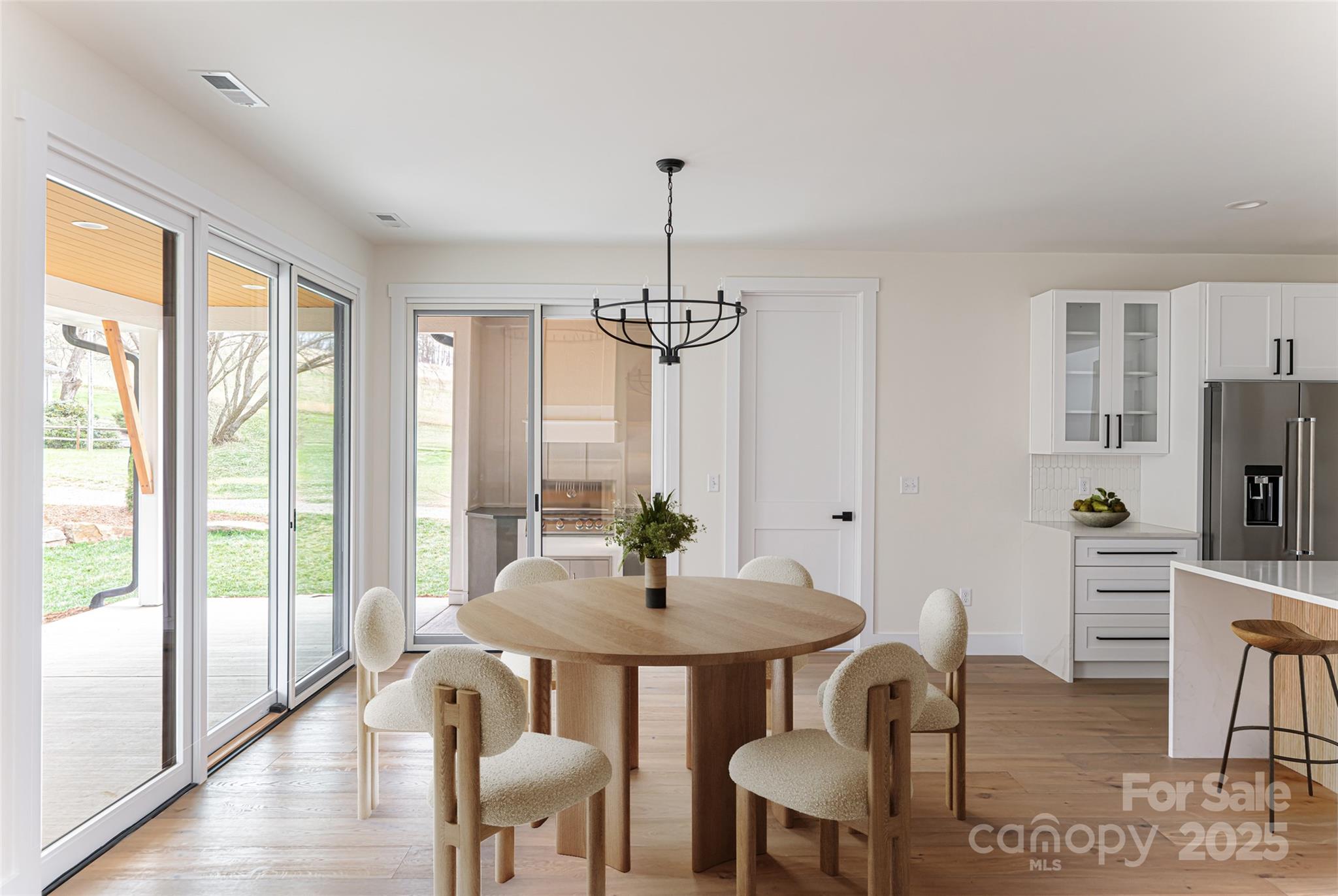 251 Bee Tree Road Swannanoa, NC 28778 - Photo 4 of 46 a dining room with furniture a chandelier and wooden floor