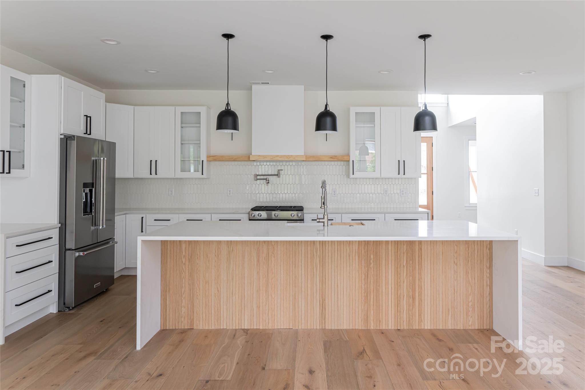 251 Bee Tree Road Swannanoa, NC 28778 - Photo 5 of 46 a kitchen with stainless steel appliances granite countertop a refrigerator a sink and a stove