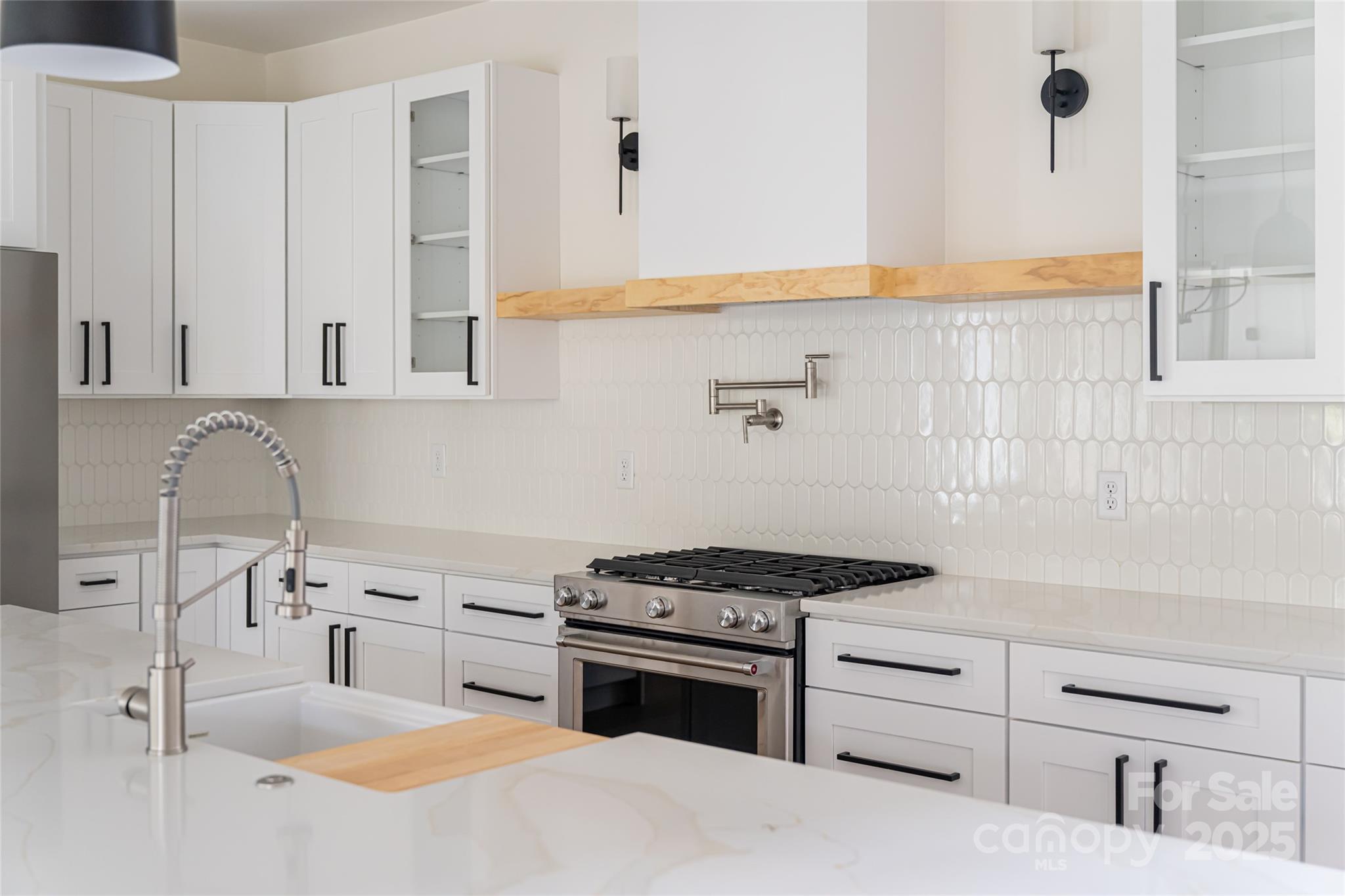 251 Bee Tree Road Swannanoa, NC 28778 - Photo 6 of 46 a kitchen with granite countertop a sink stove and cabinets
