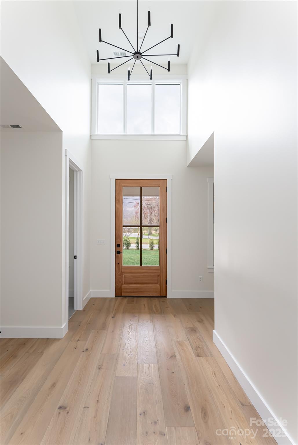 251 Bee Tree Road Swannanoa, NC 28778 - Photo 10 of 46 a view of an empty room with wooden floor and a window