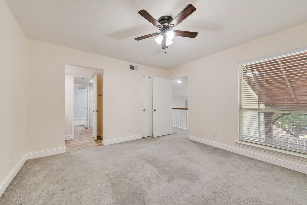 219 West Rochelle Road Irving, TX 75062 - Photo 21 of 29 Carpeted room featuring a ceiling fan, a window with horizontal blinds, and a built-in closet with bi-fold doors
