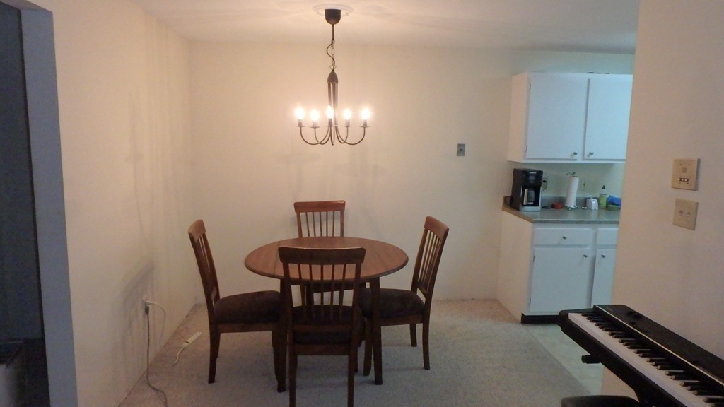 6 Post Oak Lane, Unit 4 Natick, MA 01760 - Photo 7 of 18 a view of a dining room with furniture and chandelier