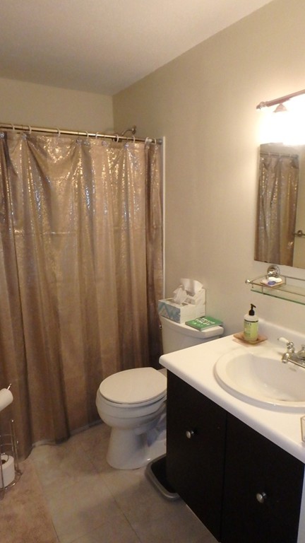 6 Post Oak Lane, Unit 4 Natick, MA 01760 - Photo 9 of 18 a bathroom with a sink vanity mirror and toilet
