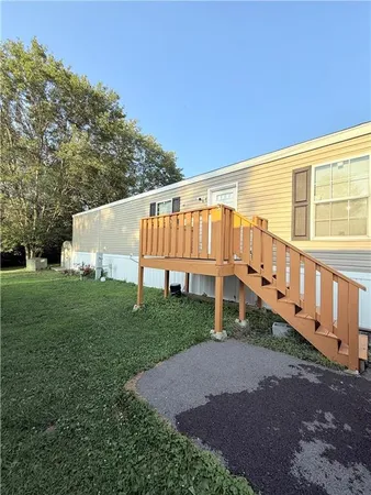 a view of a house with backyard and deck
