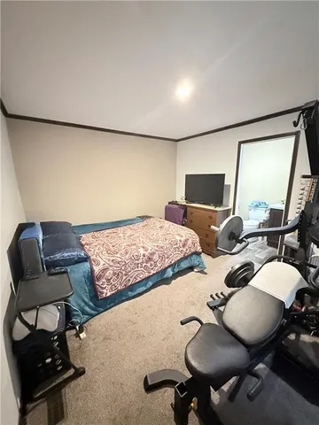 a bedroom with a bed and a chair