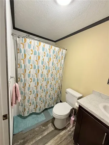 a white toilet sitting next to a shower curtain