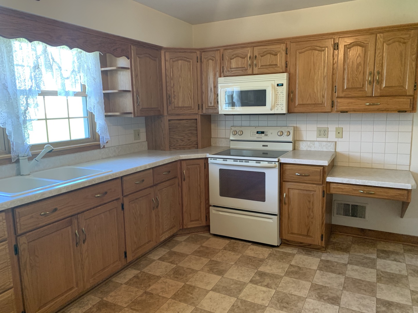 212 West Iowa Street Spring Valley, IL 61362 - Photo 9 of 18 a kitchen with a stove sink and microwave