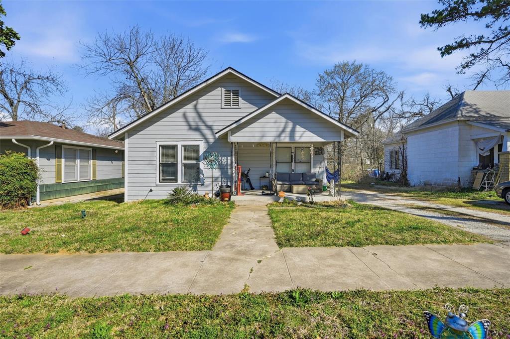 417 East Morton Street Denison, TX 75021 - Photo 4 of 9 a front view of a house with garden