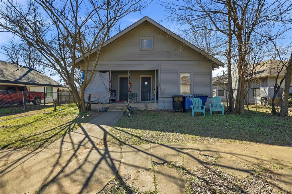 417 East Morton Street Denison, TX 75021 - Photo 7 of 9 a view of a house with a yard patio and a fire pit