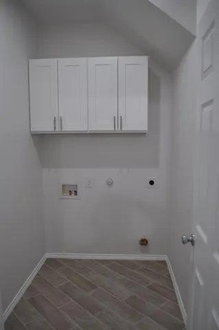 a view of an empty room and wooden floor