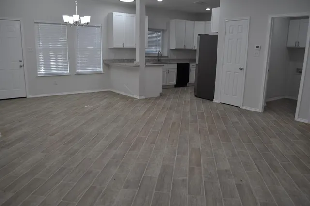 a view of a yard with plants and trees