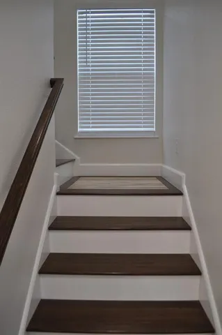 a kitchen with granite countertop white cabinets and sink