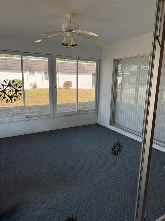 3957 Lakeside Way, Unit 143 Sarasota, FL 34232 - Photo 13 of 26 wooden floor in an empty room with a window
