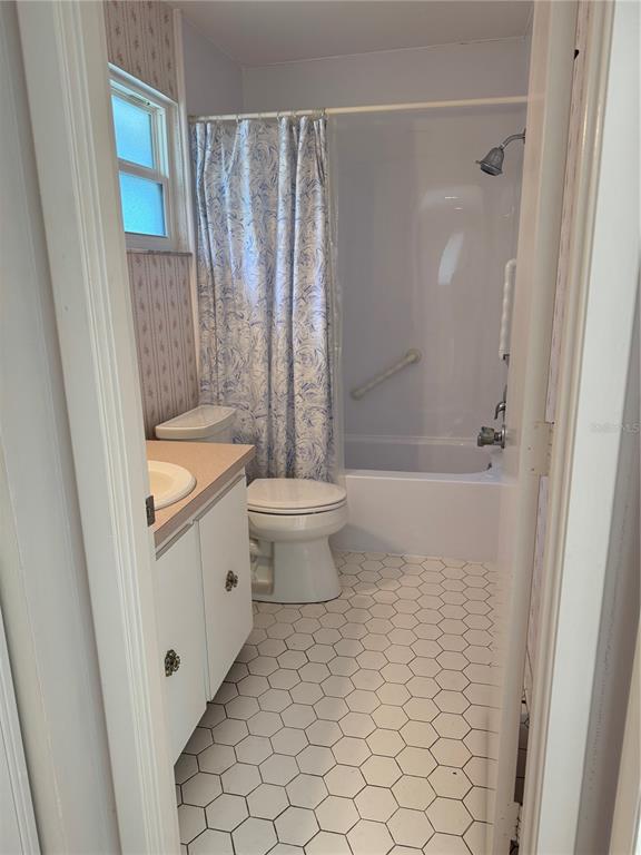 3957 Lakeside Way, Unit 143 Sarasota, FL 34232 - Photo 15 of 26 a bathroom with a granite countertop sink a toilet and shower