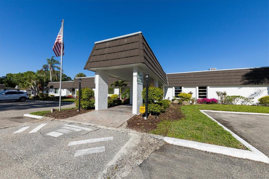 3957 Lakeside Way, Unit 143 Sarasota, FL 34232 - Photo 24 of 26 a view of a house with a yard