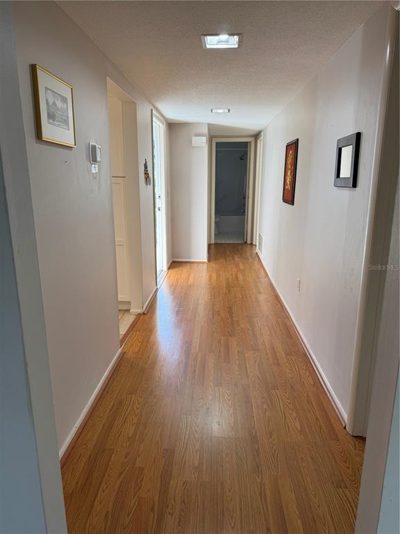 3957 Lakeside Way, Unit 143 Sarasota, FL 34232 - Photo 3 of 26 a view of hallway with wooden floor