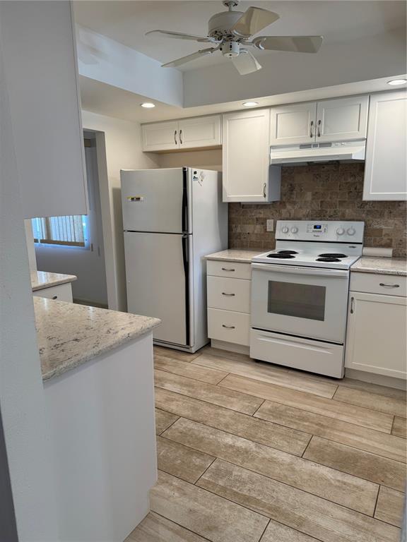 3957 Lakeside Way, Unit 143 Sarasota, FL 34232 - Photo 7 of 26 a kitchen with stainless steel appliances granite countertop a stove a sink and a refrigerator