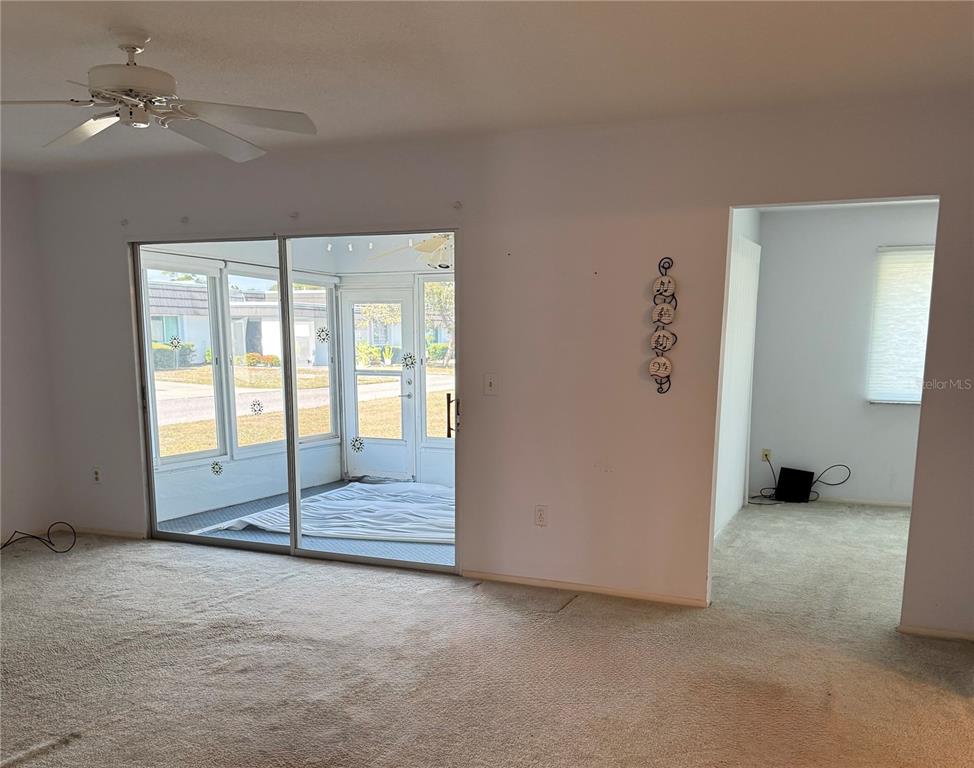 3957 Lakeside Way, Unit 143 Sarasota, FL 34232 - Photo 9 of 26 an empty room with ceiling fan and window