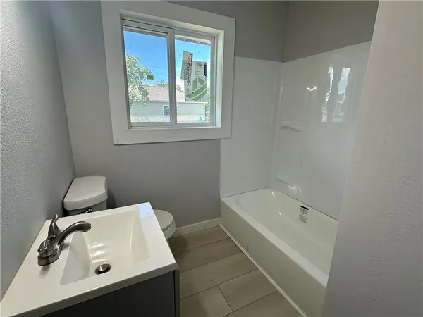 a bathroom with a bathtub sink and toilet