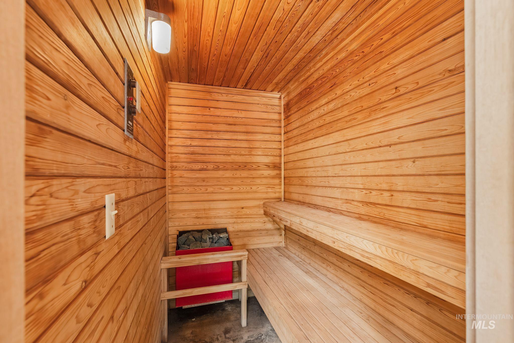 531 Silcott Road Clarkston, WA 99403 - Photo 20 of 43 Sauna featuring wood-plank walls and ceiling, built-in wooden benches, and an integrated sauna heater