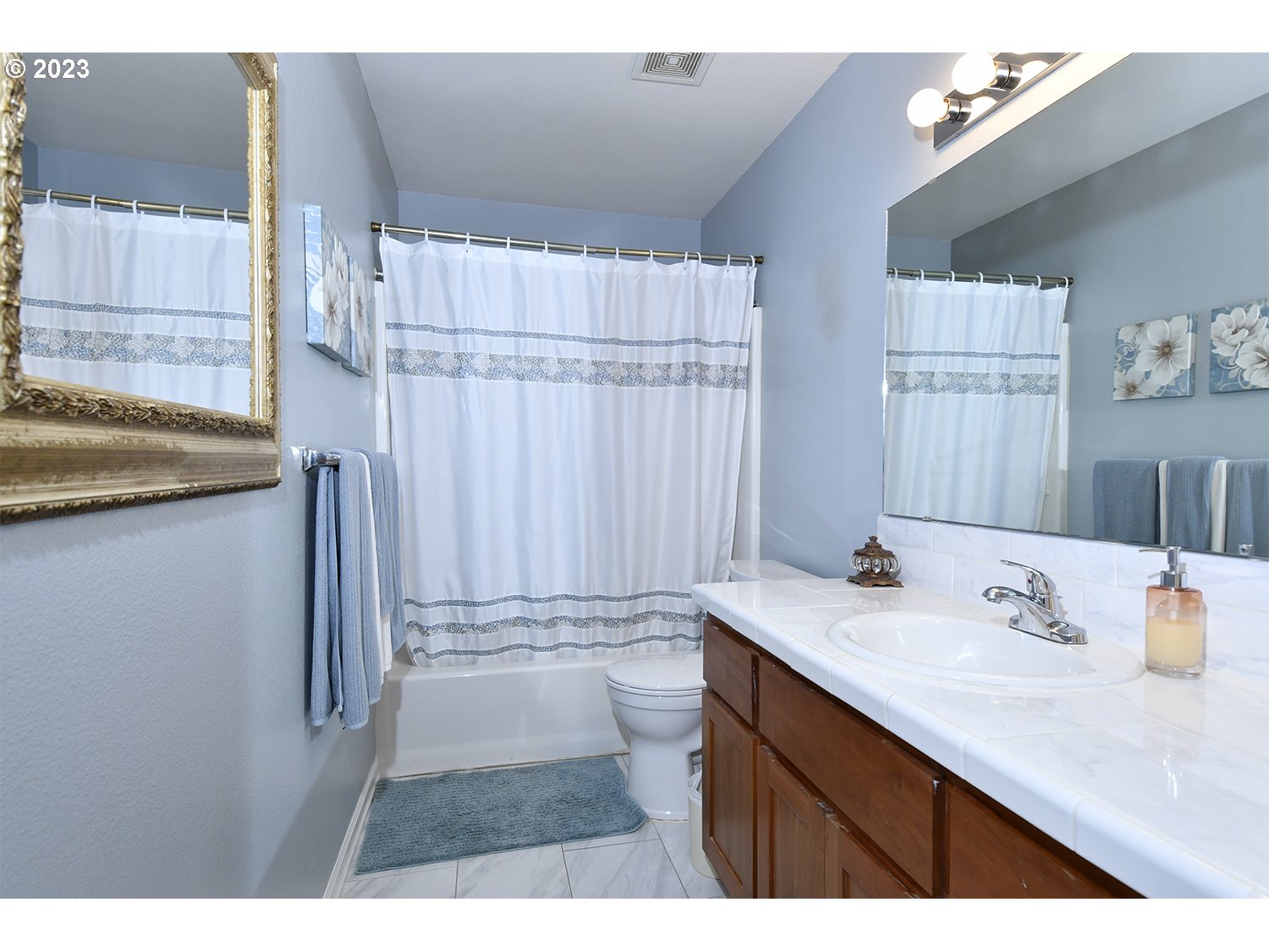 2112 Northwest 10th Street Battle Ground, WA 98604 - Photo 27 of 29 a bathroom with a sink vanity granite tub shower and a mirror