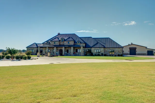 a large kitchen with stainless steel appliances granite countertop a stove a sink and a refrigerator