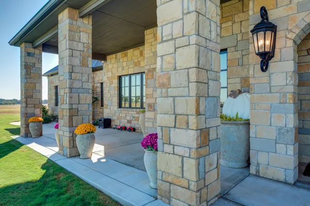 a view of a kitchen with stainless steel appliances granite countertop a refrigerator and a stove top oven