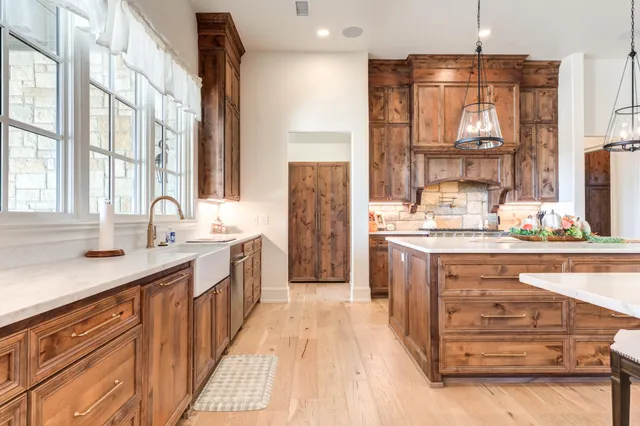 a view of a patio with dining table and chairs under an umbrella