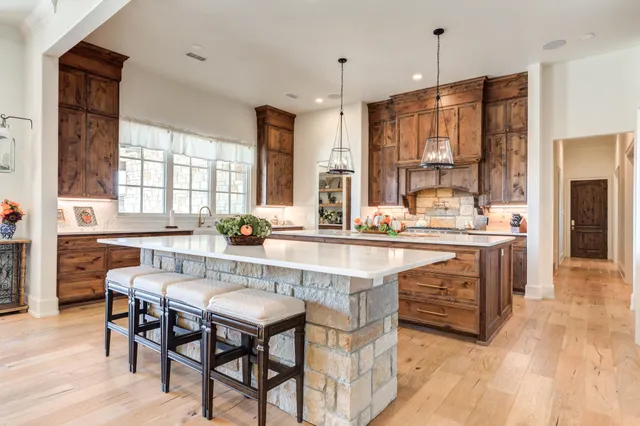 an aerial view of a house with a garden and lake view