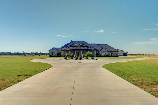 a living room with furniture and large window