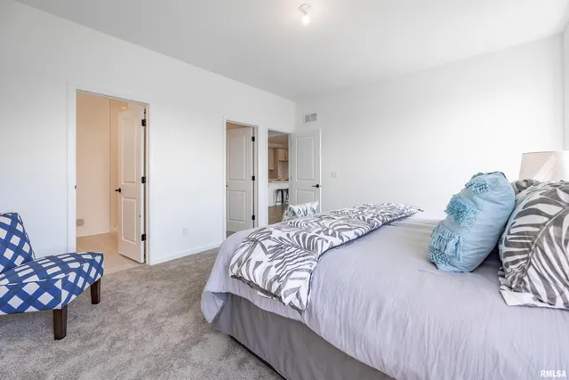 a bedroom with a bed and a couch