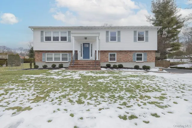 a view of a house with a yard covered in snow