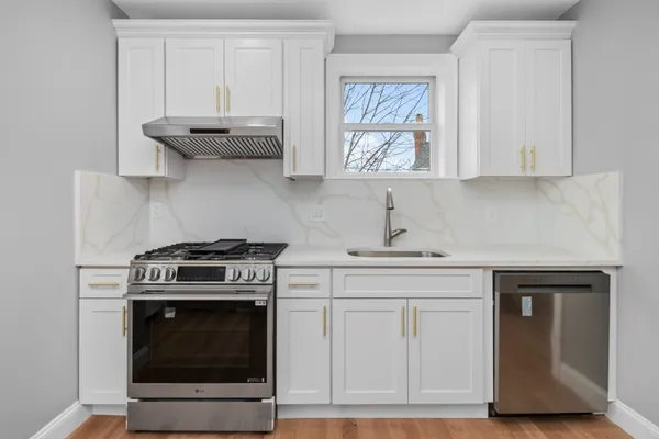 a kitchen with cabinets appliances and a window