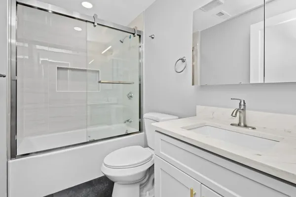 a bathroom with a sink toilet and shower