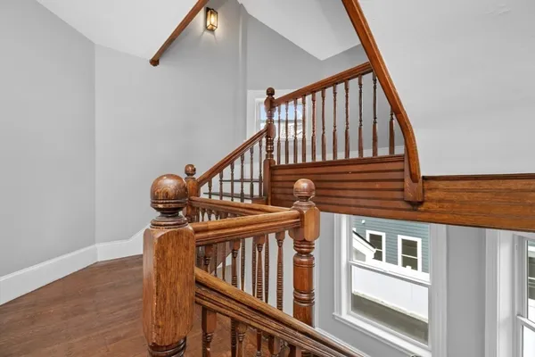 a view of entryway with wooden floor and stairs