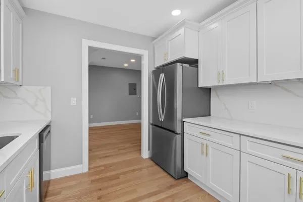 a kitchen with a refrigerator and a sink