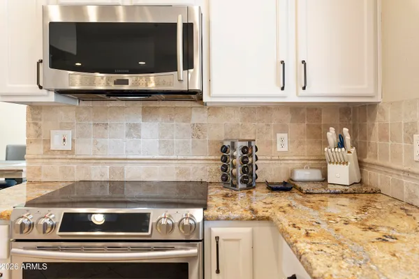 a kitchen with granite countertop a sink and a window
