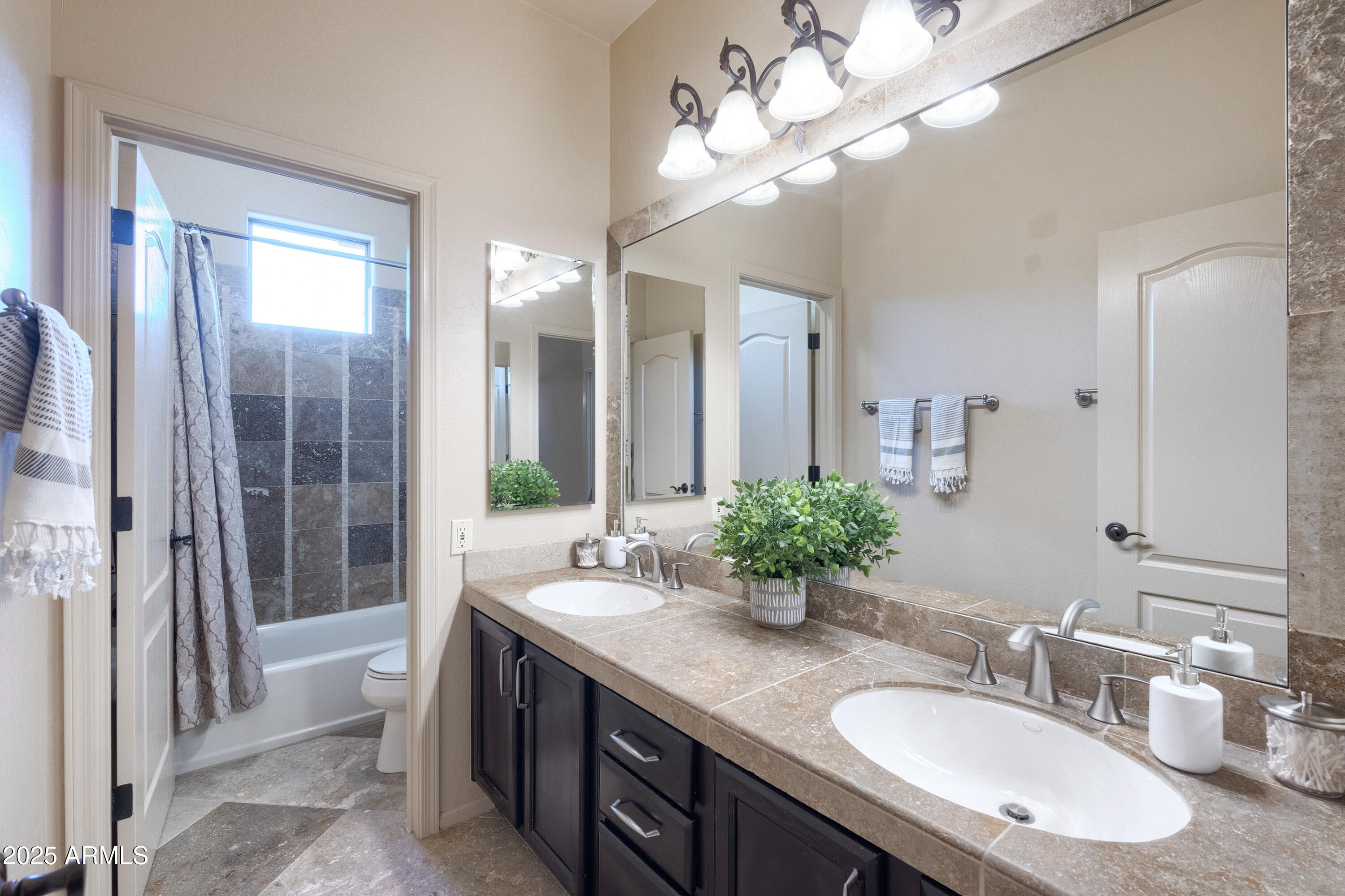6419 East Betty Elyse Lane Scottsdale, AZ 85254 - Photo 15 of 33 a bathroom with a double vanity sink and a mirror